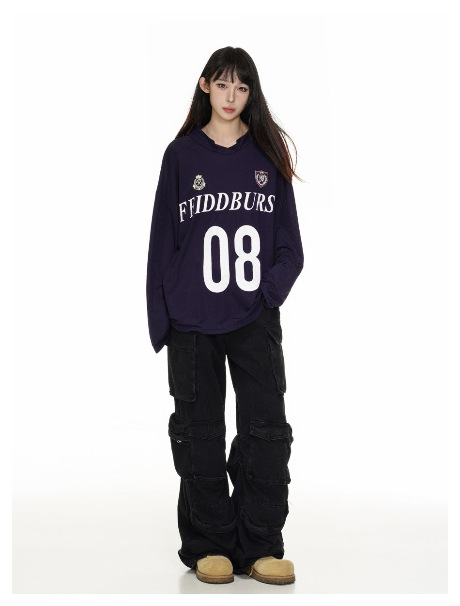 Full-length model wearing an oversized dark navy hooded jersey with crest graphics and a large white 08.