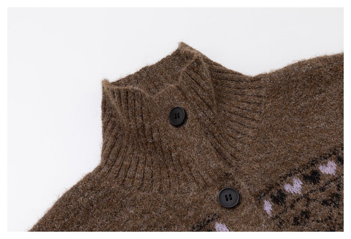 Close-up of a brown knit cardigan collar with two black buttons and part of a lavender motif.