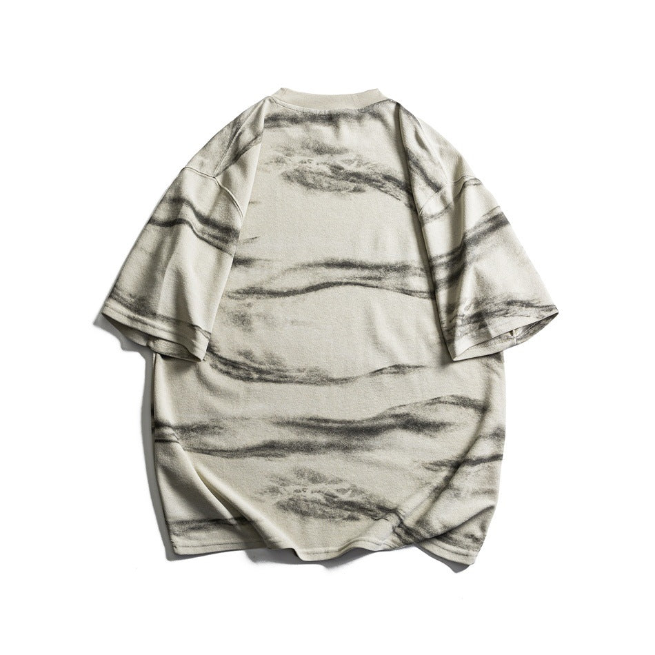 Back view of beige short-sleeve T-shirt with gray horizontal brushstroke pattern, flat lay