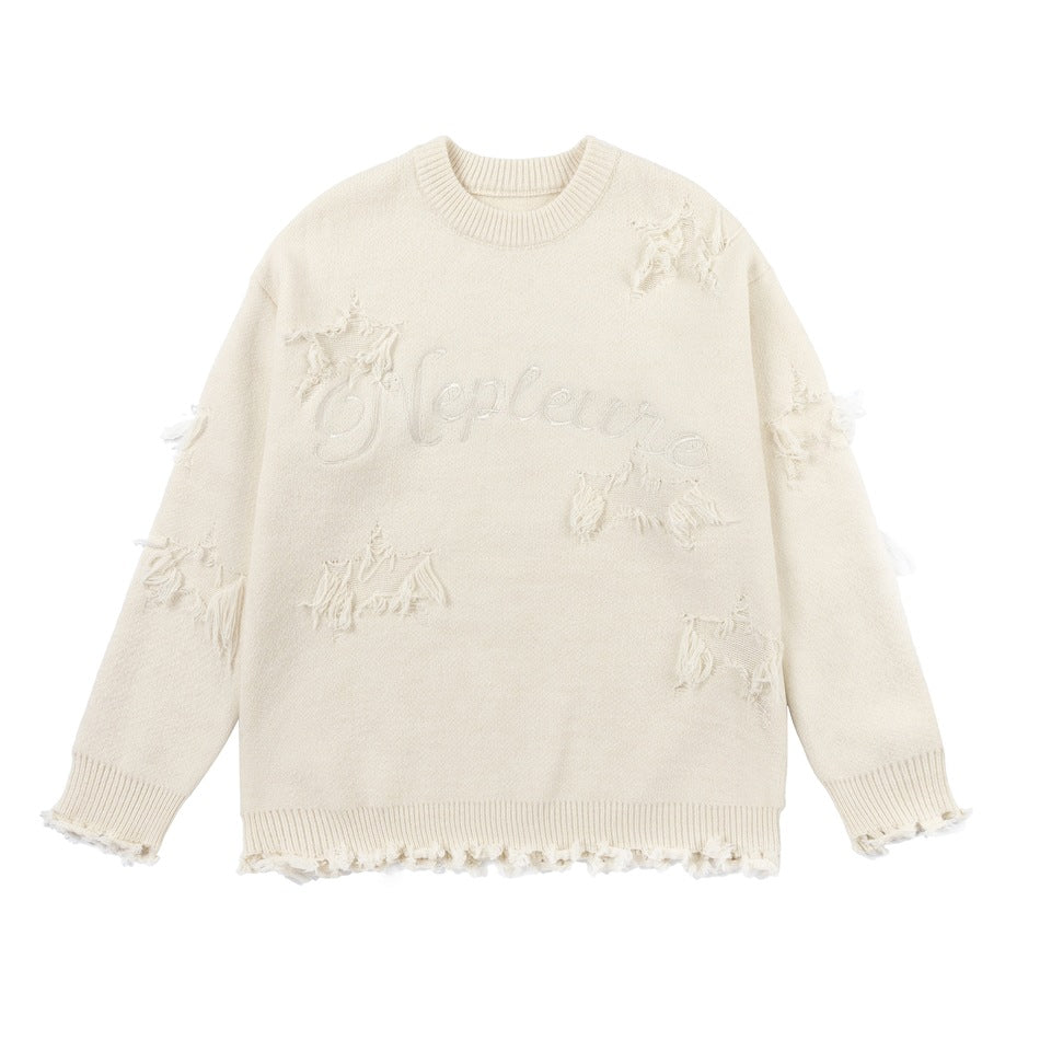Apricot cream distressed knit crew-neck sweater flat lay with frayed star patches and embroidered lettering