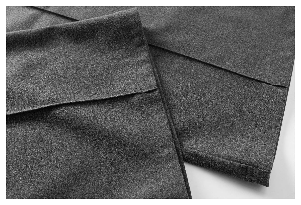 Close-up of charcoal-gray pant legs showing folded hems and stitched cuffs.