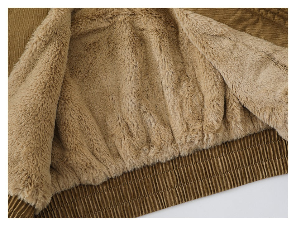 Close-up of the jacket's beige plush lining and gathered tan hem.