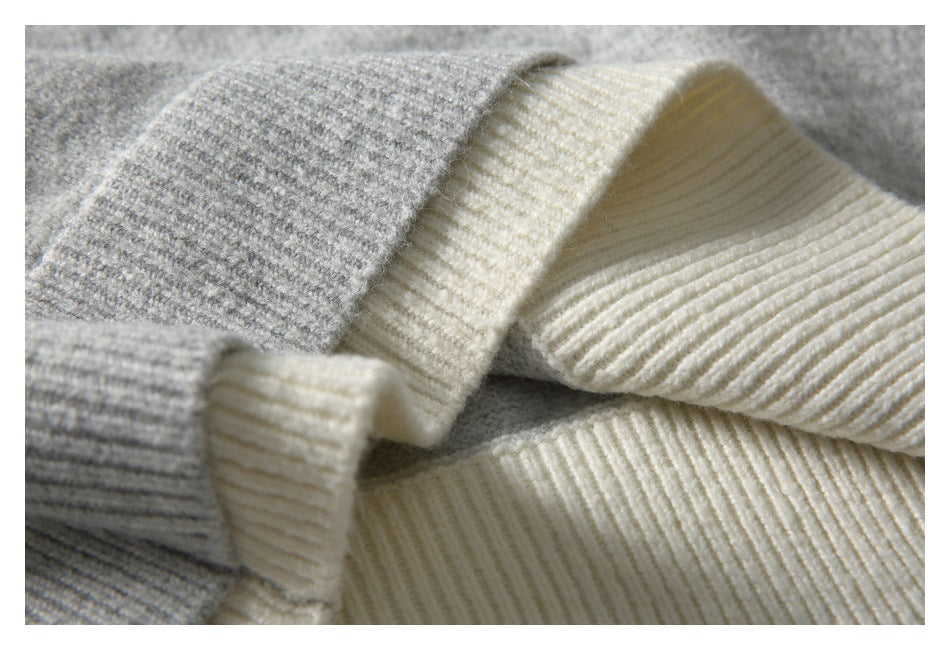 Close-up of cream ribbed knit trim folded over gray knit fabric.