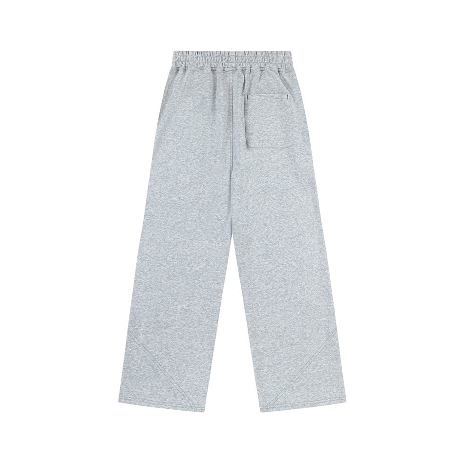 Back view of light gray wide-leg pants with an elastic waist and a single patch pocket.