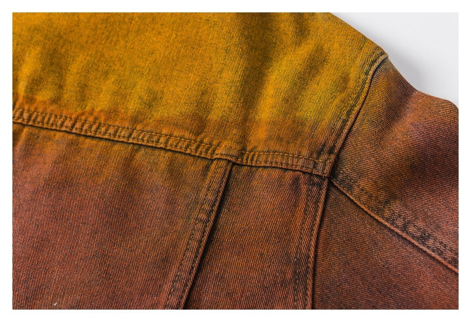 Close-up of ochre and rust-brown garment fabric with stitched panel seams.