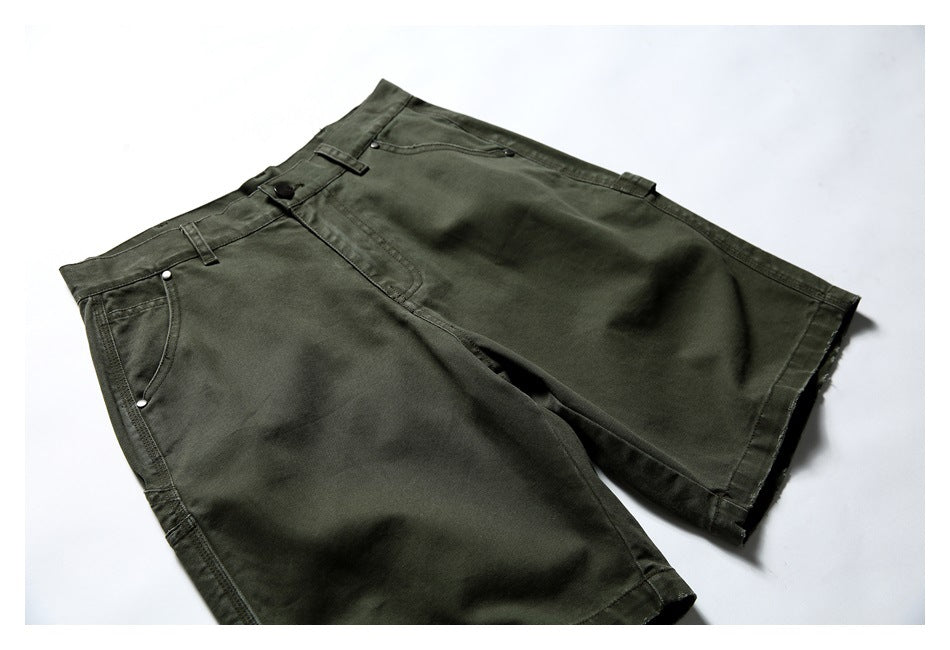 Angled flat lay of olive utility shorts showing the button waist, front pockets, and long legs.