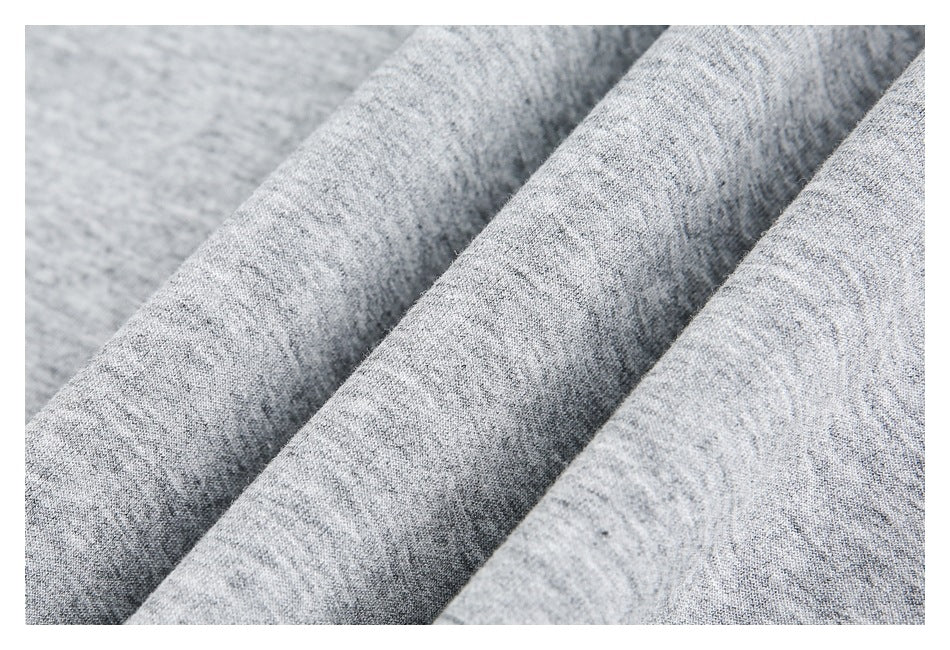 Close-up of heather gray fabric arranged in soft folds, showing its surface texture.