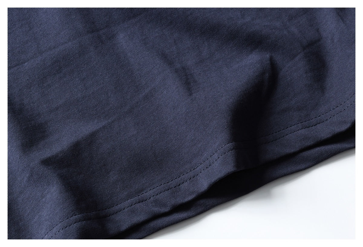 Close-up of the double-stitched hem on navy fabric.