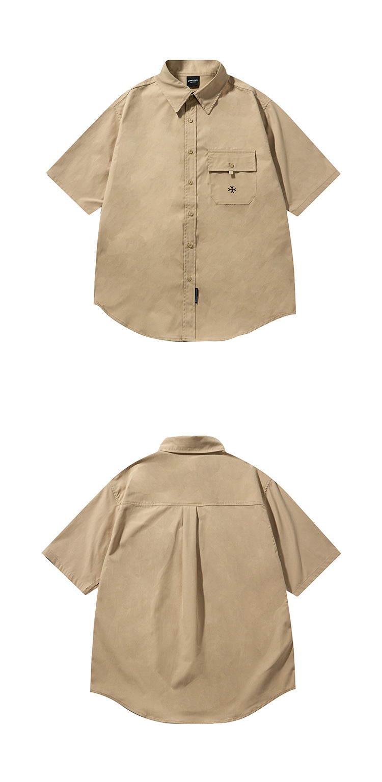 Beige short-sleeve button-up shirt shown from the front above its back view; it has a flap chest pocket and curved hem.