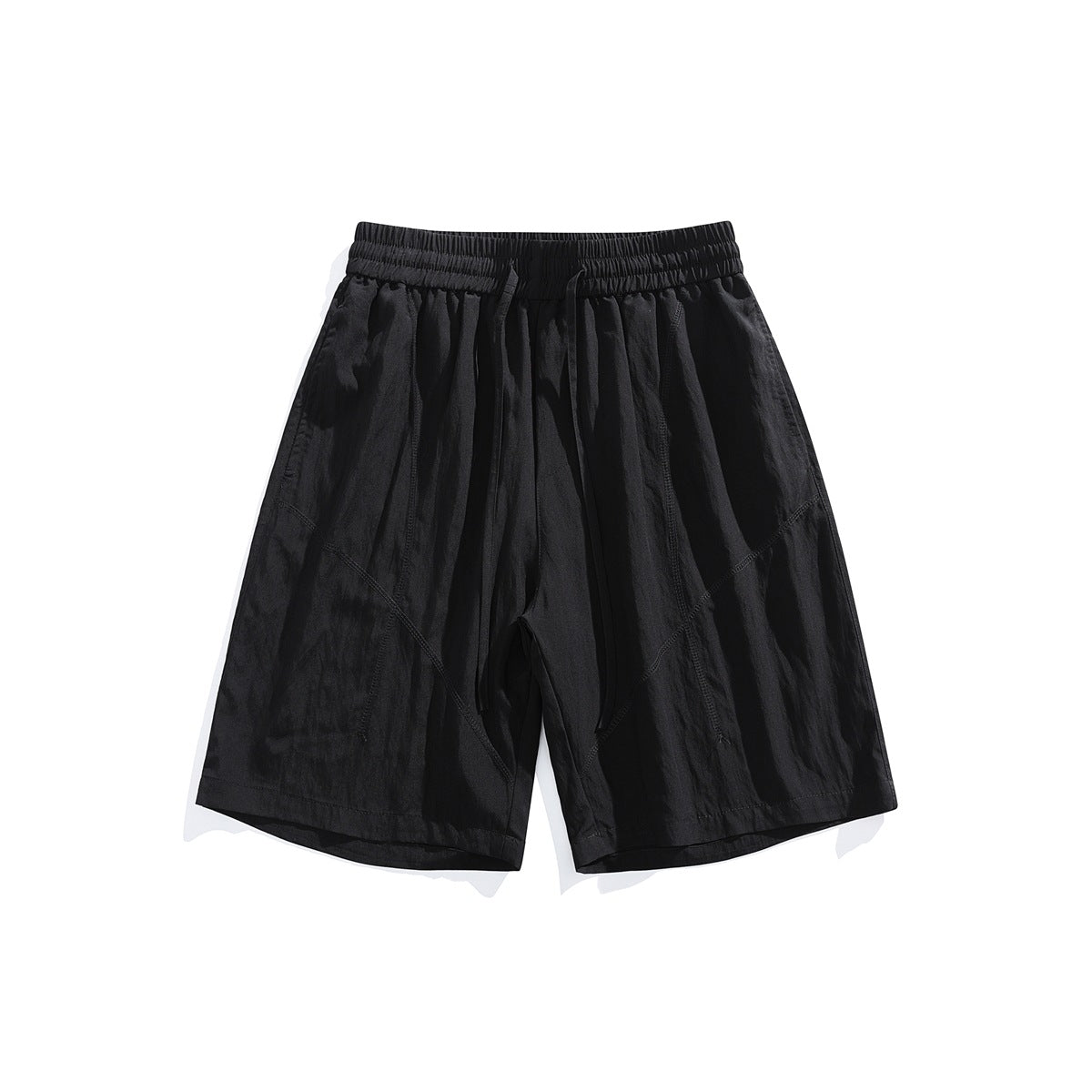 Black knee-length shorts with elastic drawstring waist and diagonal topstitched seams, front flat lay