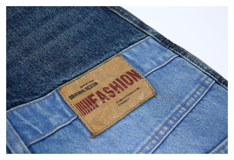 Close-up of a tan leather-style jeans patch with English lettering on light blue denim.