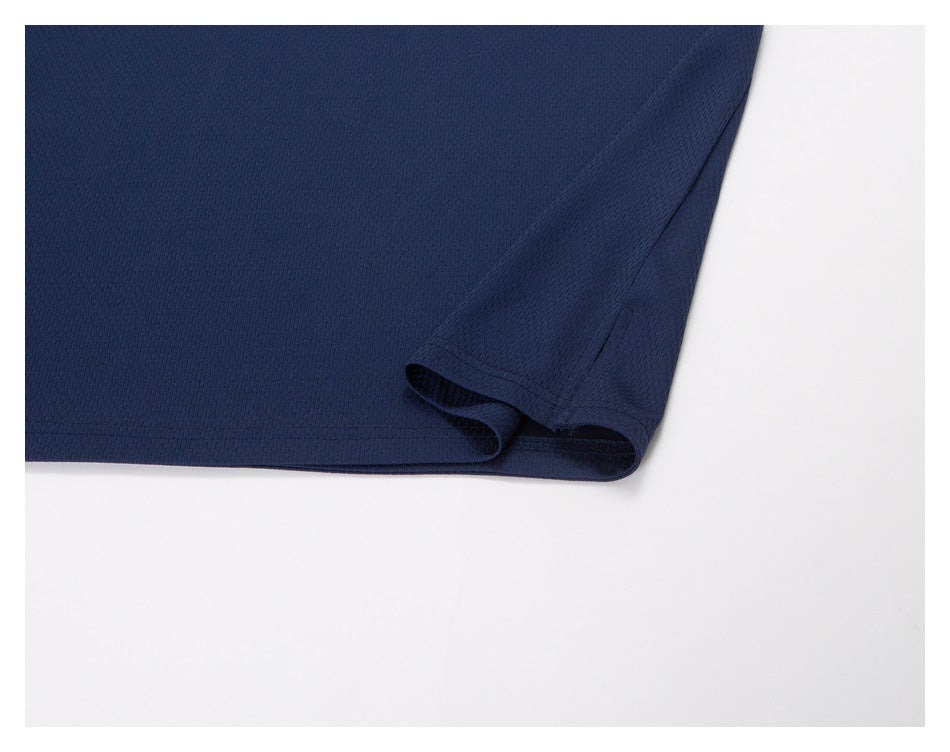 Close-up of the navy top's stitched hem and folded edge.