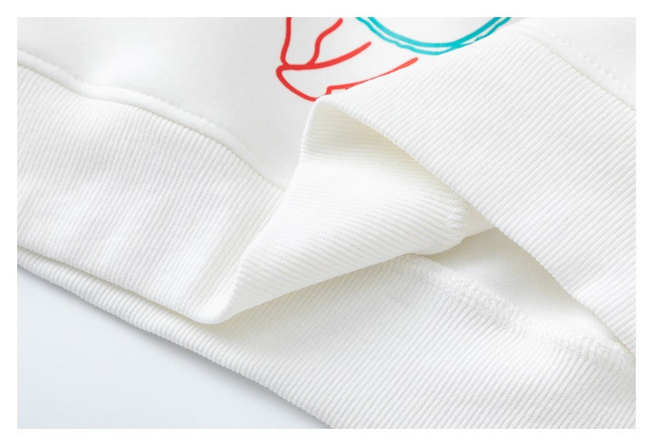 Close-up of a white sweatshirt's ribbed cuff and folded seam.