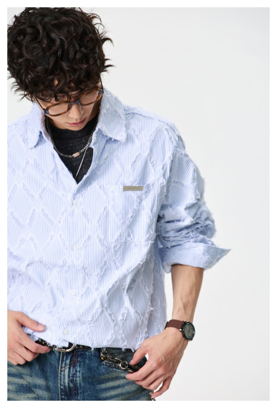 Close view of a model wearing the pale blue pinstriped shirt, highlighting its raised diamond texture and chest pocket.