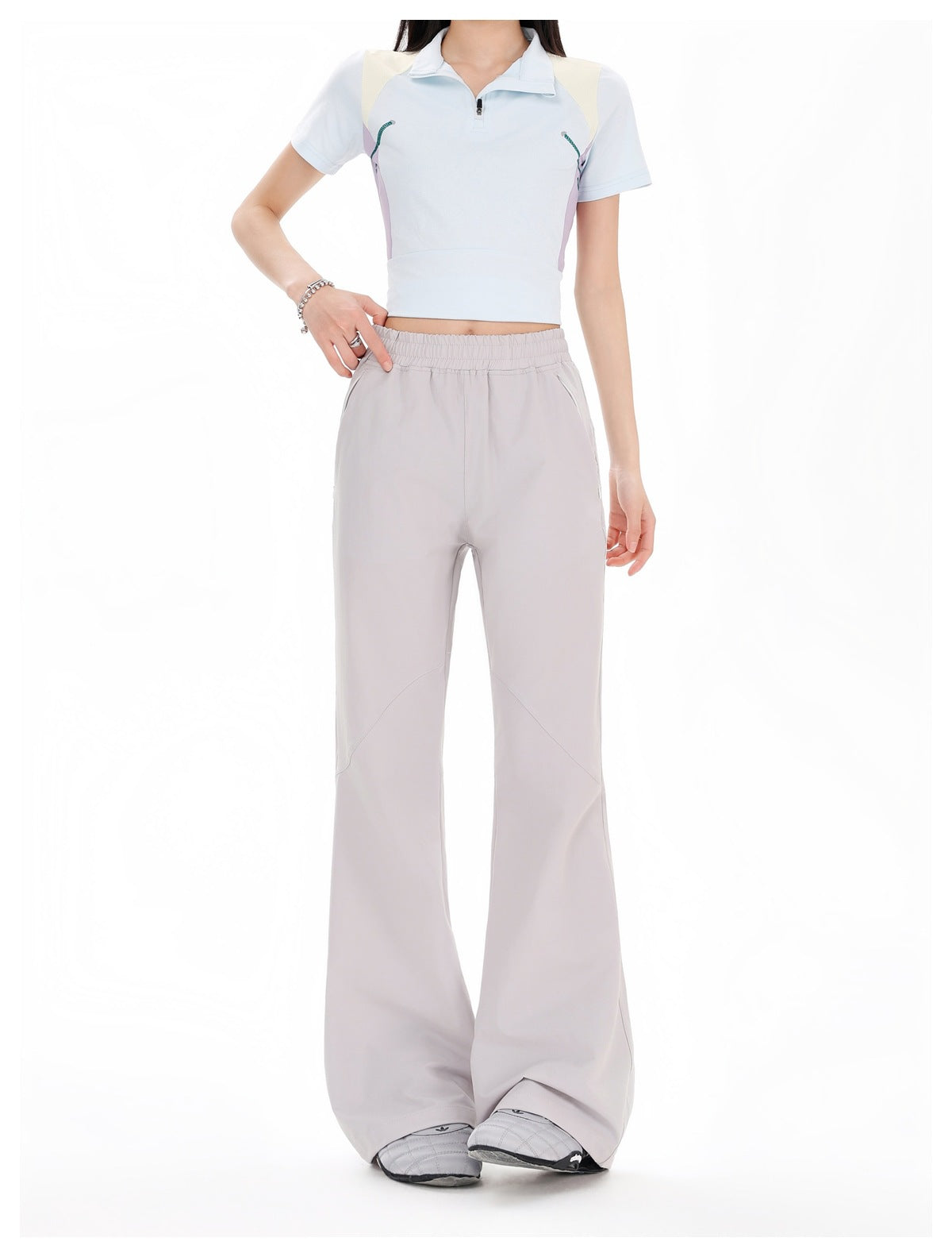 Front view of a model wearing pale gray wide-leg pants with an elastic waist and a light blue color-block polo.
