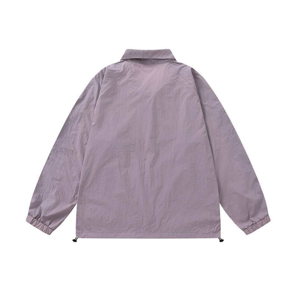 Back view of purple crinkled lightweight jacket with raglan sleeves, elastic cuffs, and hem drawcord toggles
