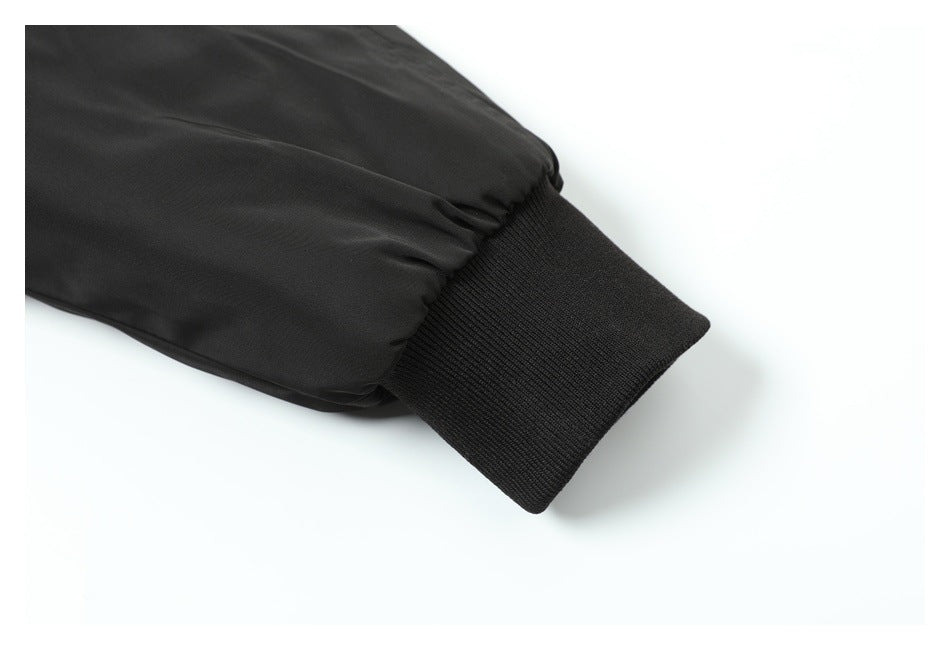 Close-up of a black sleeve ending in a wide ribbed cuff.