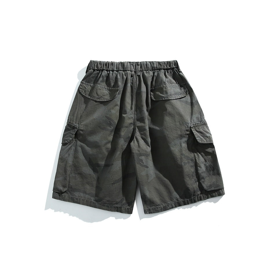Back view of dark gray camouflage cargo shorts with an elastic waist, rear flap pockets, and side cargo pockets.