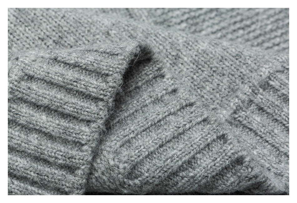Close-up of a ribbed gray sweater cuff folded against the knitted body.