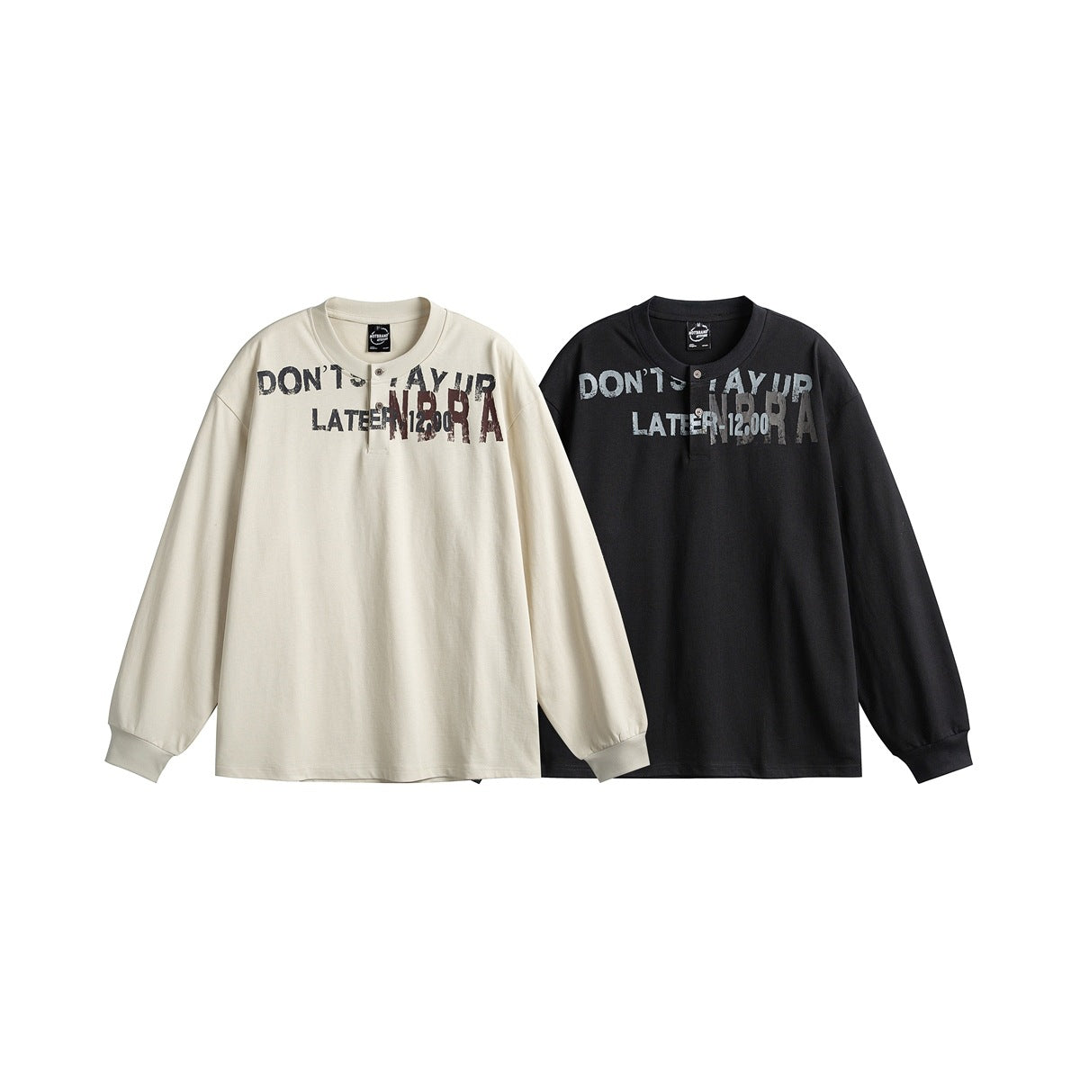 Two long-sleeve henley shirts shown from the front, one cream and one black, both with distressed chest lettering.