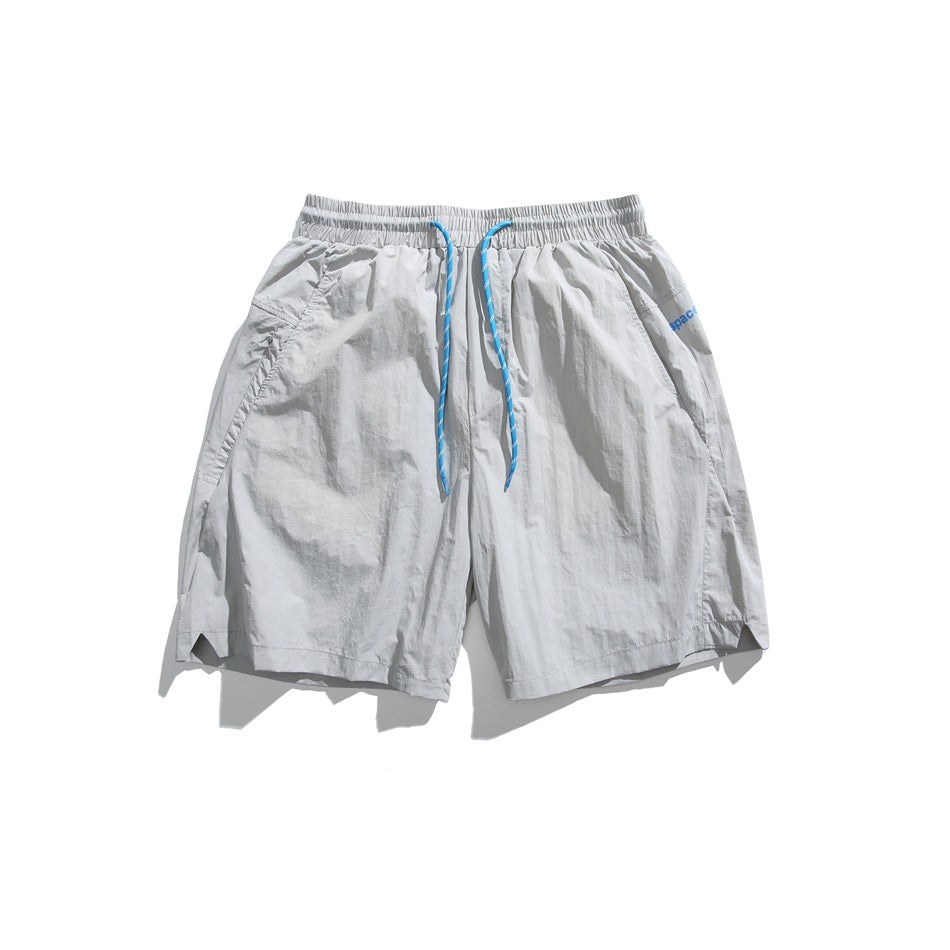 Light gray drawstring shorts with blue cord, flat lay front view