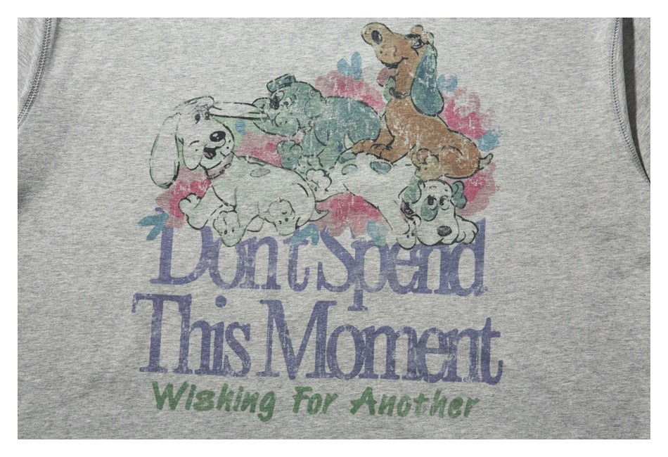 Close-up of a faded cartoon dog print and English lettering on a light gray T-shirt.