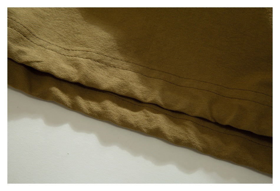 Close-up of the tan garment's double-stitched hem.