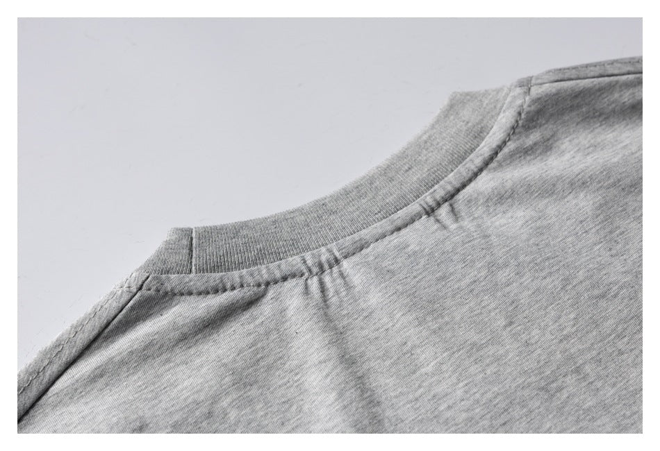 Close-up of the back neckline and shoulder seam of a heather gray T-shirt.