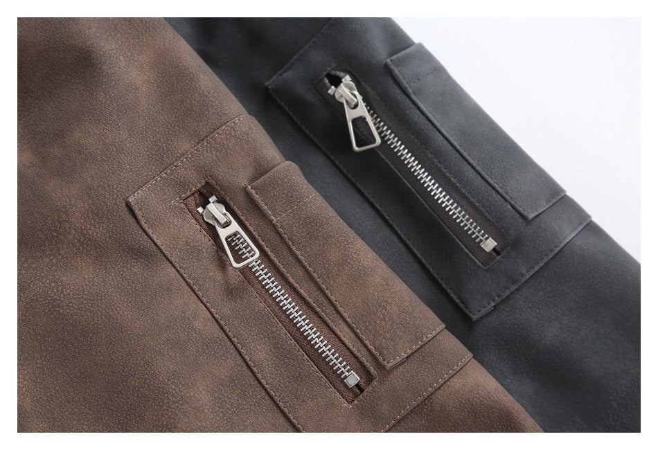 Close-up of brown and charcoal jacket panels, each with a silver zippered pocket.