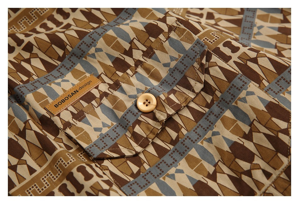 Close-up of the shirt's patterned chest pocket, tan button and sewn BOOSAN design label.