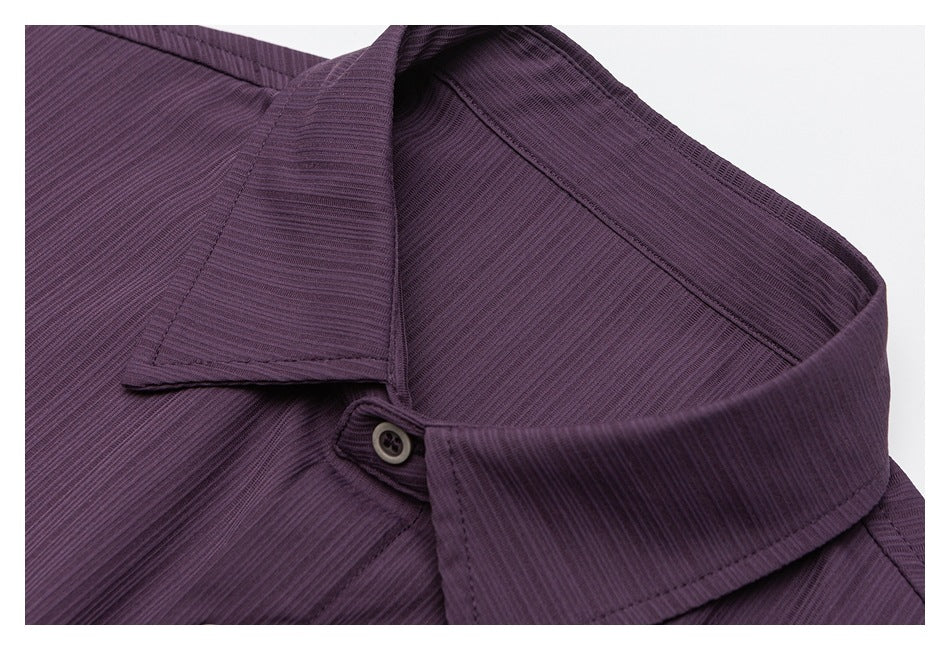 Close-up of the plum-purple shirt's pointed collar, stitching and top button.