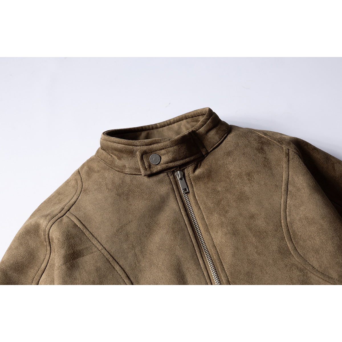 Close-up of a taupe-brown jacket front with a snap-tab stand collar, metal zipper, and curved seams.