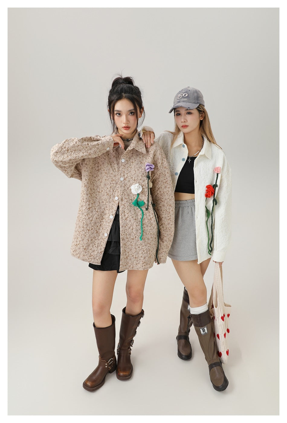 Two models wearing oversized floral jackets with colorful flower appliqués; one beige and one ivory.