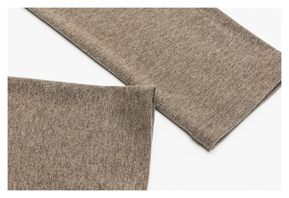 Close-up of a heathered taupe-brown garment sleeve with a stitched edge.