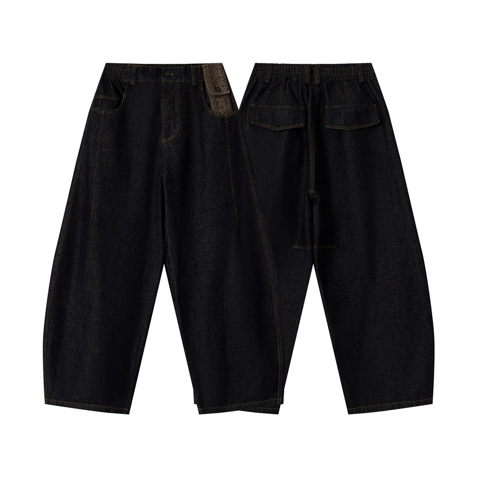 Dark indigo wide-leg jeans shown from the front and back, with front and rear pockets and a patterned waistband detail.