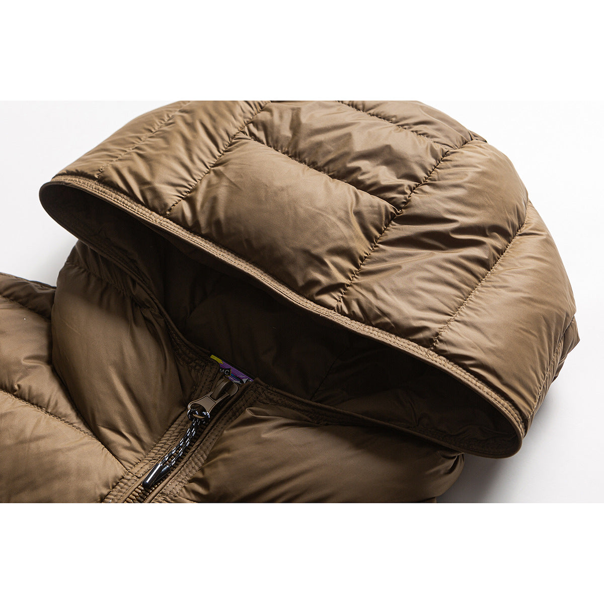 Close-up of a brown quilted jacket showing its hood opening, lining, and upper zipper.