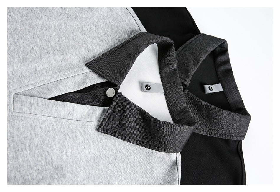 Close-up of gray and black pullovers showing their contrasting collars, inner labels, and neckline openings.