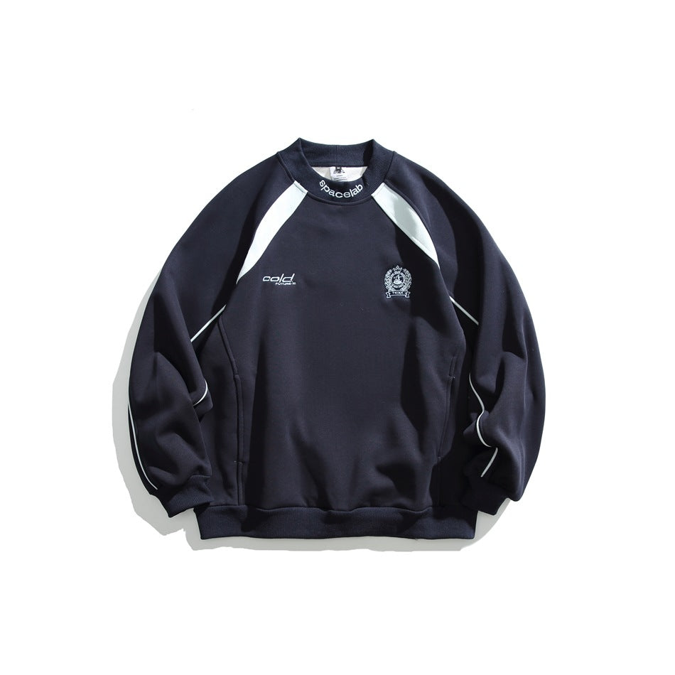 Navy blue crewneck sweatshirt with pale raglan shoulder panels, sleeve piping, embroidered chest crest and ribbed trims, flat