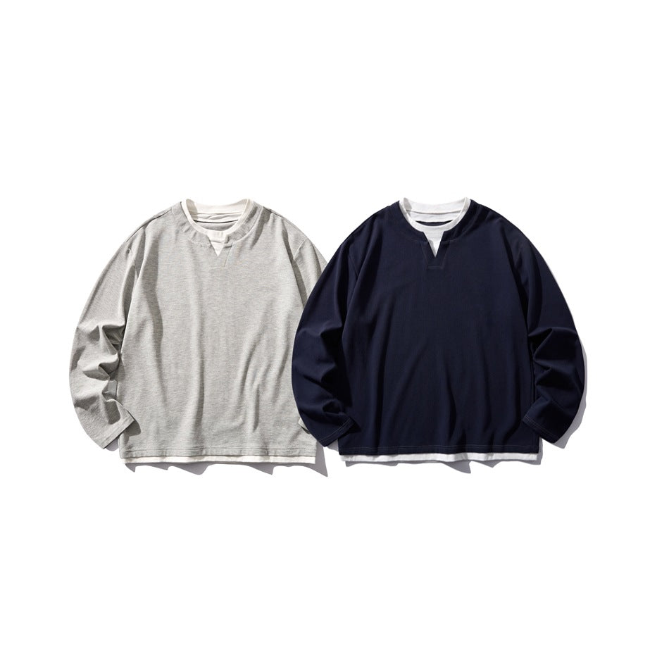 Two long-sleeve tops shown from the front: one light gray and one navy, both with white layered crew necks and V notches.