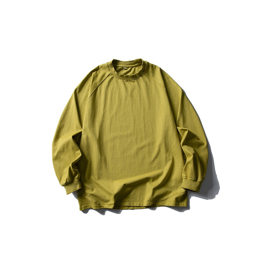 Yellow long-sleeve raglan crew-neck T-shirt flat lay, front view