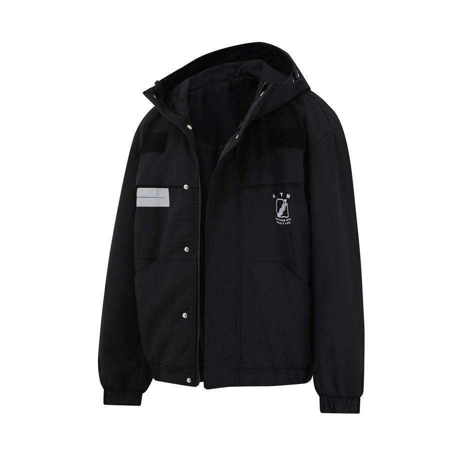Angled front view of a black hooded jacket with a partly open snap-and-zip front, reflective strips, and a small chest