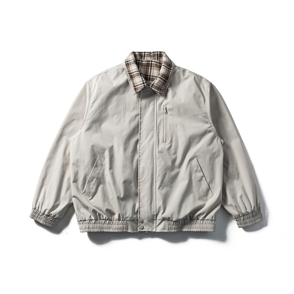 Beige-apricot collared jacket with beige plaid collar, zip chest pocket, slanted pockets and elastic cuffs and hem, flat lay