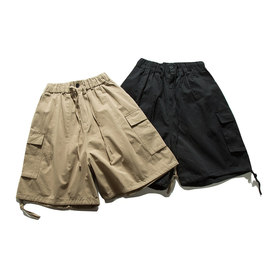 Front view of cargo shorts in khaki and black, with elastic waistbands, drawcords, and side pockets.