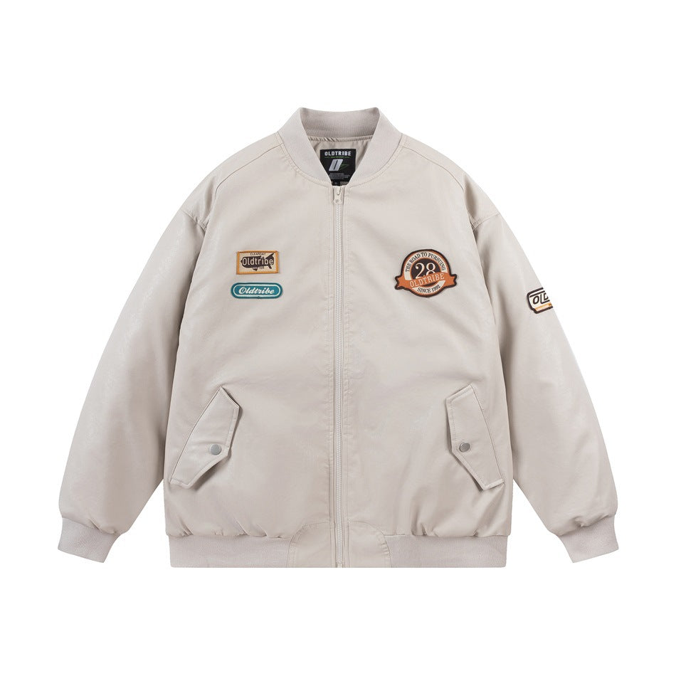 Front view of an ivory bomber jacket with a zip closure, ribbed trim, flap pockets, and embroidered patches.