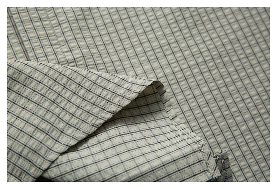 Close-up of folded checked shirt fabric and a finished seam.
