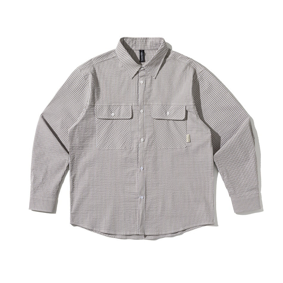 Gray and white striped textured long-sleeve button-up shirt with two chest flap pockets, flat front view
