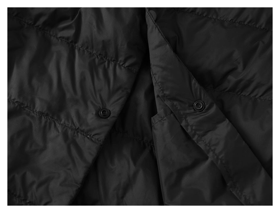 Close-up of the black vest's open front placket, revealing the inside snap fasteners.