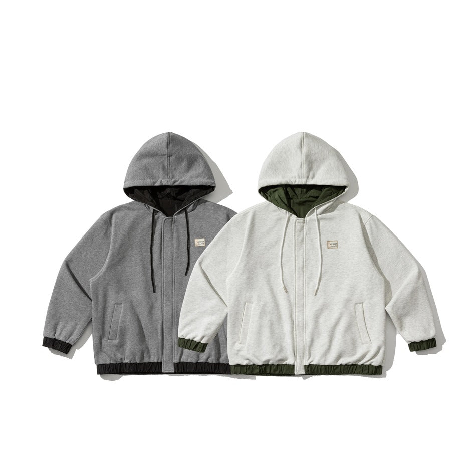 Two hooded zip jackets displayed side by side in charcoal gray and light gray, with contrasting dark linings and gathered