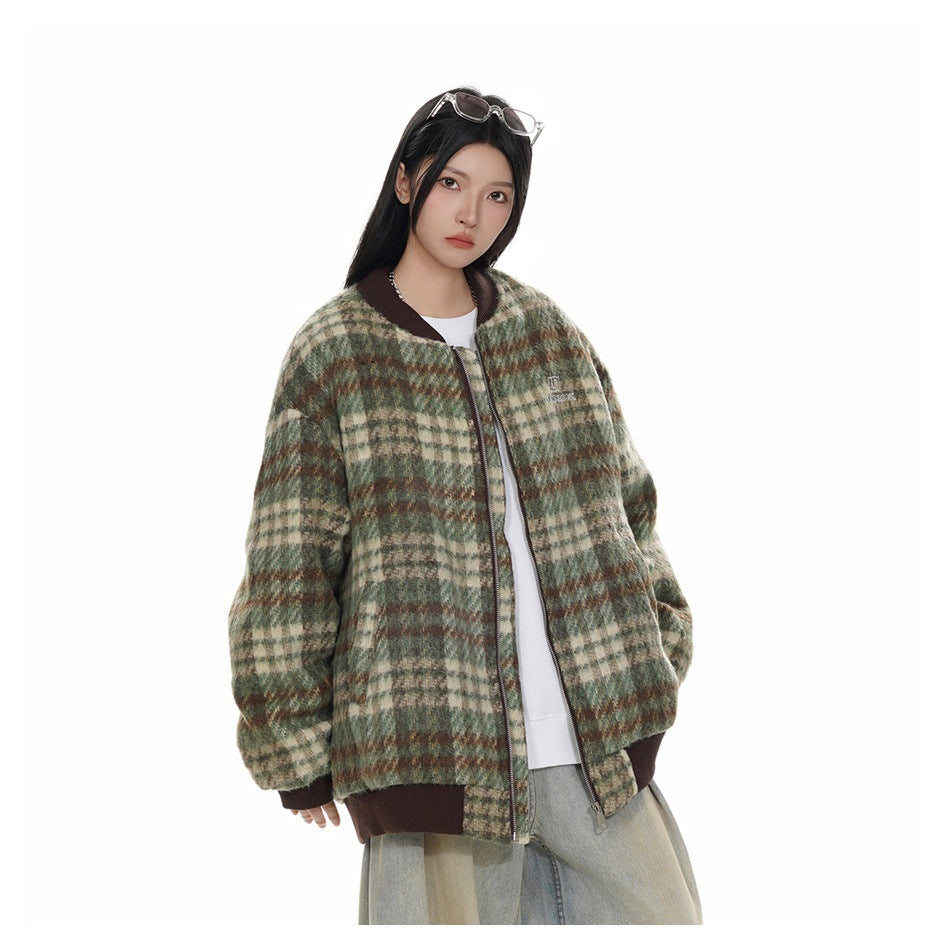 Model wearing a green plaid bomber jacket open over a white top with light wide-leg jeans, three-quarter view
