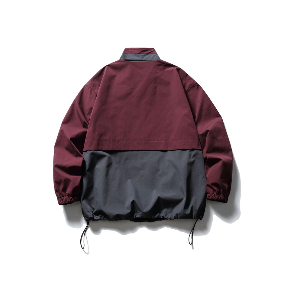Back view of burgundy and charcoal gray jacket showing gray collar-back panel, overlay seam and drawcord hem